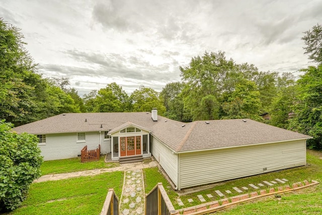 back of house with a lawn