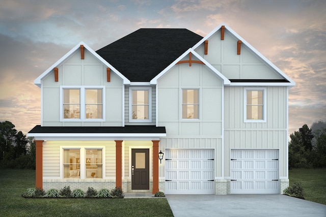 view of front of property featuring a garage and a yard