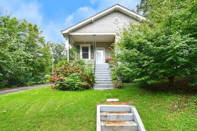 bungalow-style house featuring a front yard