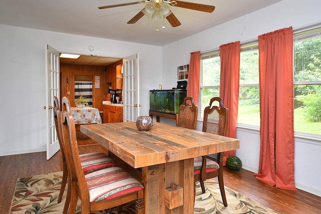 dining area featuring a wealth of natural light, ceiling fan, and dark hardwood / wood-style floors