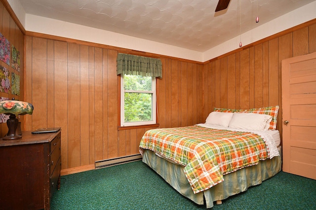 carpeted bedroom with ceiling fan, wooden walls, and a baseboard radiator