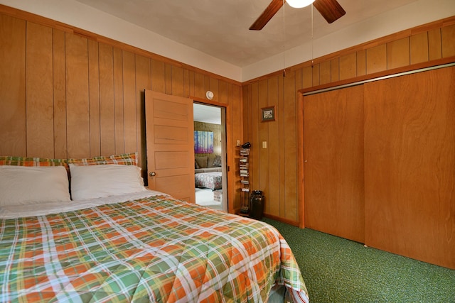 unfurnished bedroom featuring a closet, ceiling fan, wooden walls, and carpet