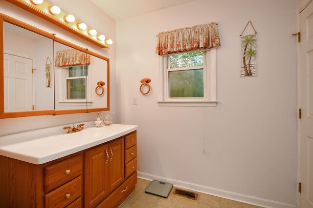 bathroom featuring visible vents, vanity, and baseboards