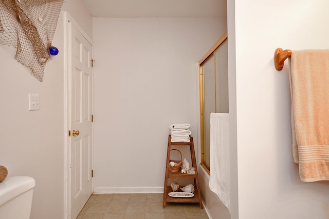 bathroom with toilet and tile patterned floors