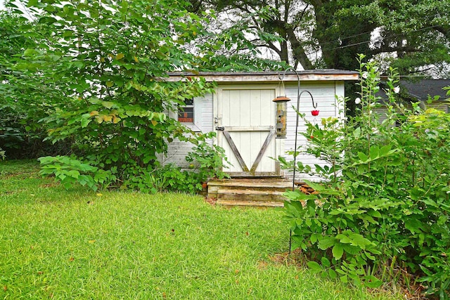 view of outbuilding with a lawn