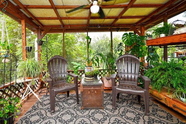 sunroom with ceiling fan, coffered ceiling, and beam ceiling