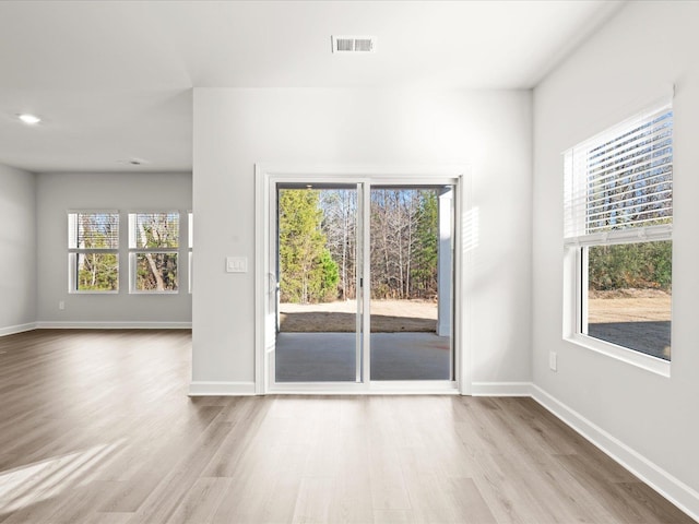 interior space featuring baseboards, visible vents, and wood finished floors