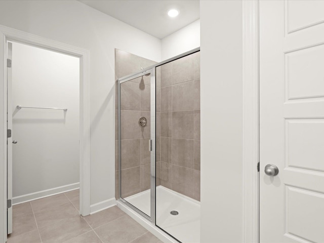 full bath featuring recessed lighting, a shower stall, baseboards, and tile patterned floors