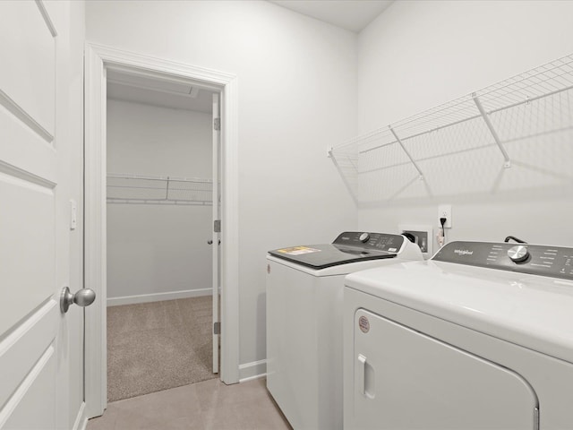 clothes washing area featuring laundry area, baseboards, light colored carpet, and independent washer and dryer