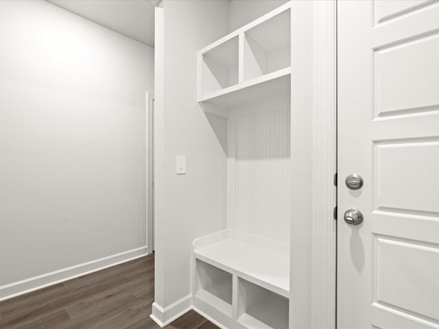 mudroom featuring dark wood-type flooring and baseboards