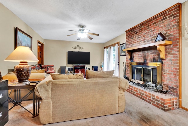 living room with ceiling fan, carpet flooring, a textured ceiling, and a brick fireplace