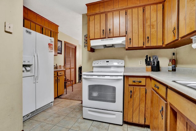 kitchen with light tile patterned flooring and white appliances