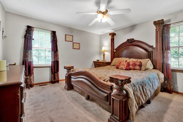 carpeted bedroom with a textured ceiling and ceiling fan