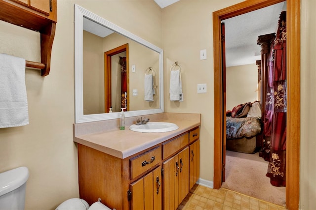 bathroom featuring tile patterned floors, toilet, and vanity