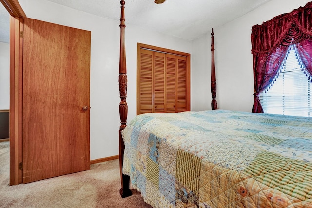 bedroom with a closet, light colored carpet, and a textured ceiling