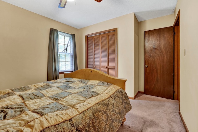 bedroom featuring a closet, ceiling fan, and carpet