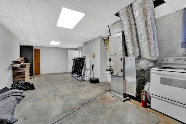 basement with heating unit and a paneled ceiling