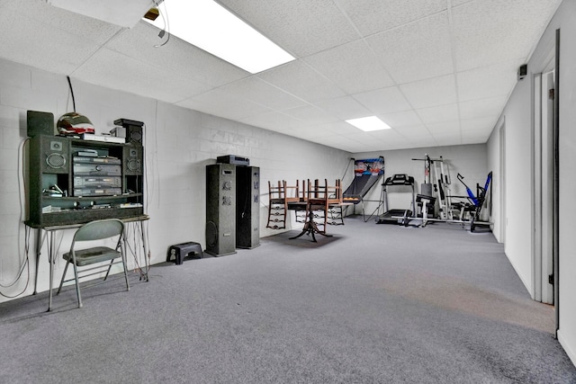 workout room featuring carpet and a drop ceiling