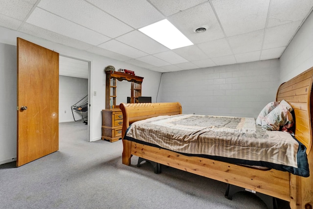 carpeted bedroom featuring a paneled ceiling