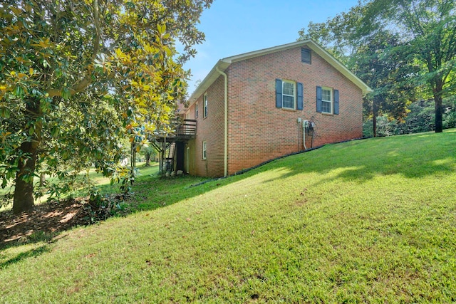 view of side of home with a yard