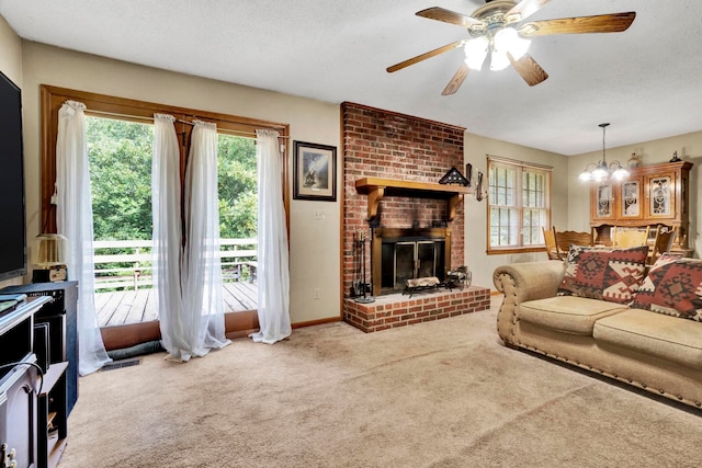 living room featuring ceiling fan with notable chandelier, carpet, a textured ceiling, and a fireplace