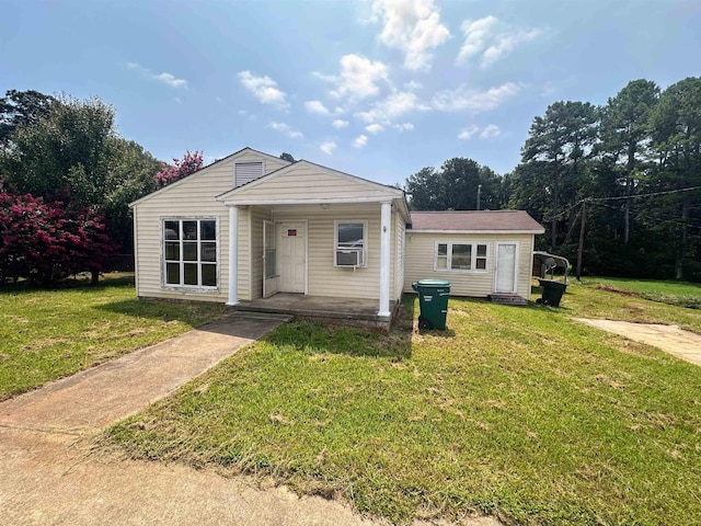 bungalow-style home featuring a front lawn