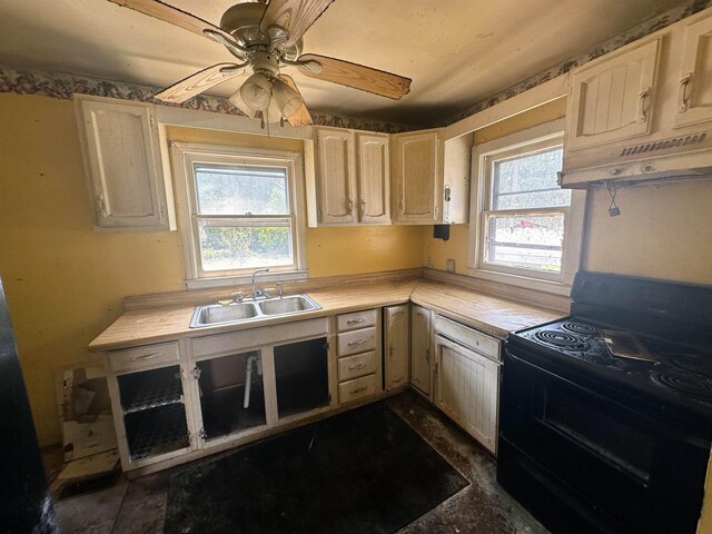 kitchen featuring ceiling fan, sink, electric range, and premium range hood