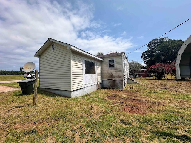 view of property exterior with crawl space and a lawn