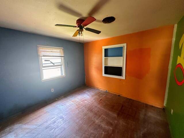 empty room featuring ceiling fan and hardwood / wood-style floors