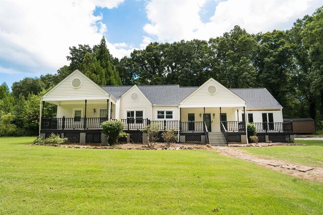 view of front of home with covered porch and a front lawn