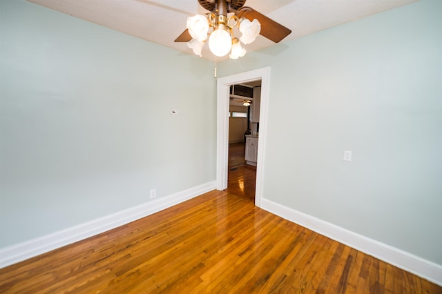 unfurnished room featuring ceiling fan and hardwood / wood-style flooring