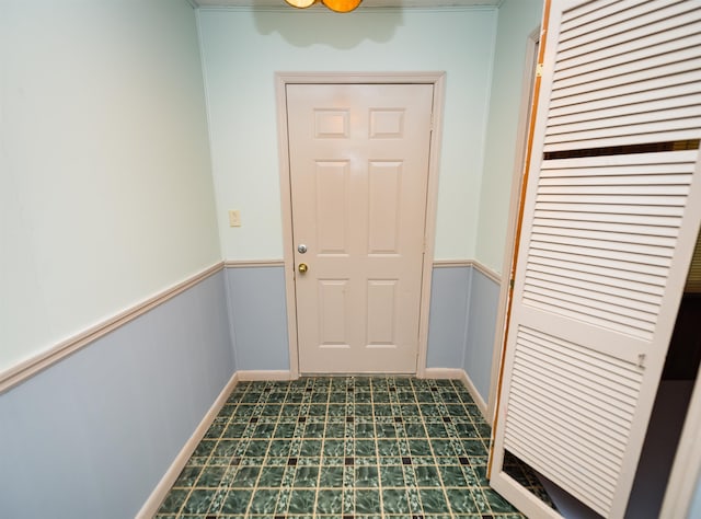 doorway to outside featuring dark tile patterned flooring