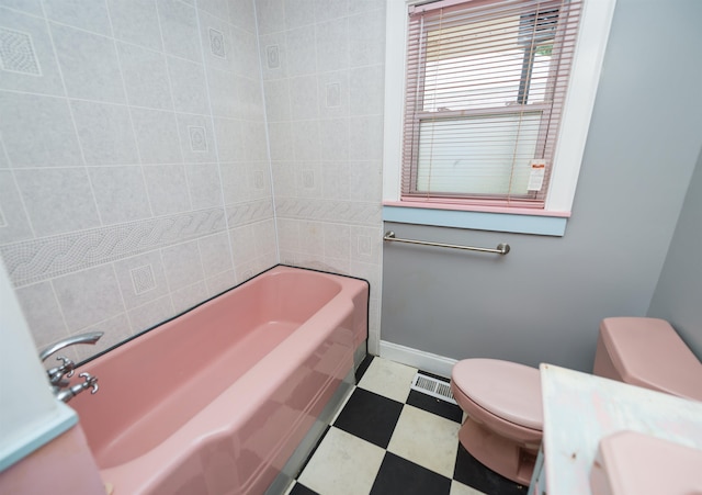 bathroom with shower / bath combination, toilet, and tile patterned flooring