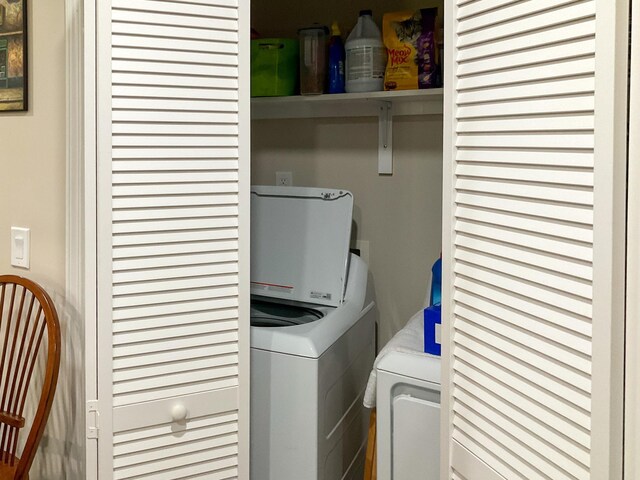 laundry area with washing machine and clothes dryer