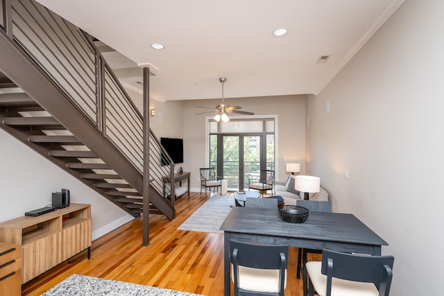 dining room featuring ceiling fan, light wood-type flooring, and ornamental molding