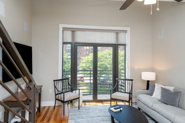 living room with ceiling fan and hardwood / wood-style floors