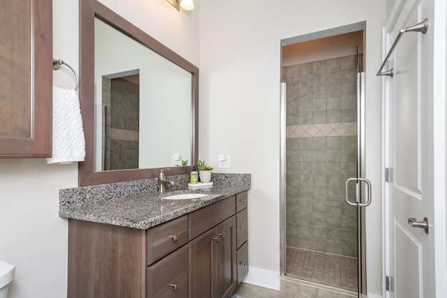 bathroom with tile patterned flooring, an enclosed shower, and vanity