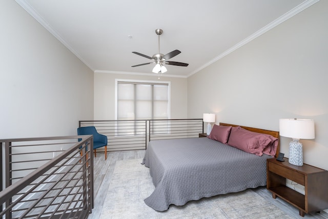 bedroom featuring ceiling fan, light hardwood / wood-style flooring, and ornamental molding