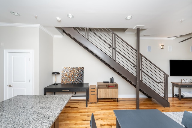 living room with light wood-type flooring and crown molding