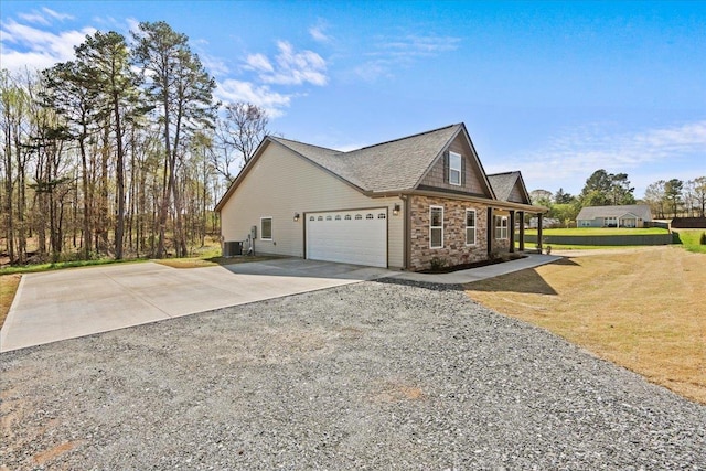 view of home's exterior with central air condition unit, a yard, stone siding, an attached garage, and concrete driveway