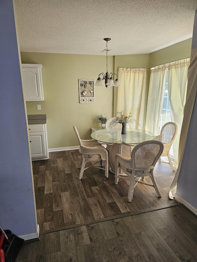 dining room with baseboards, a chandelier, and wood finished floors