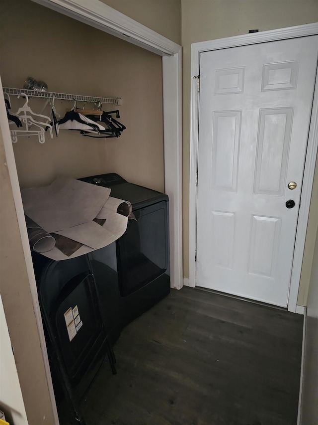 interior space with laundry area and wood finished floors