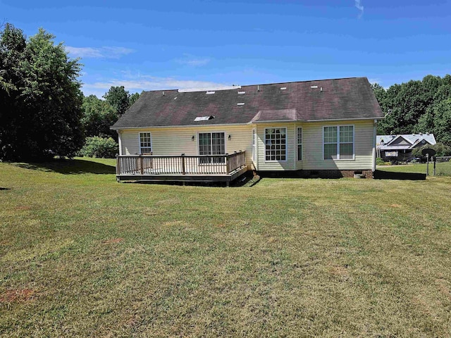 back of property featuring crawl space, a yard, and a wooden deck