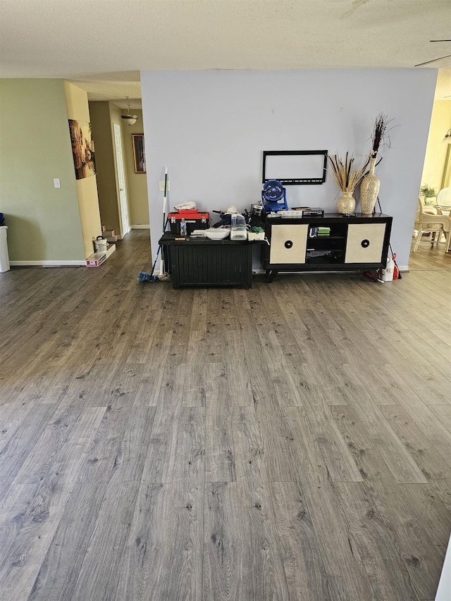 living area featuring baseboards and wood finished floors