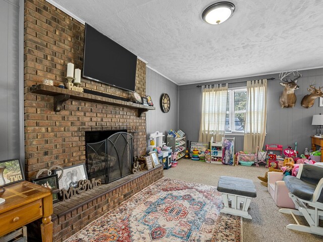 recreation room featuring carpet flooring, a textured ceiling, a brick fireplace, and brick wall