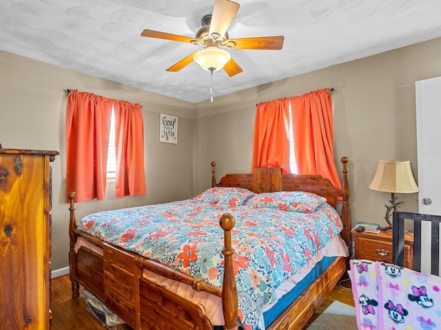 bedroom featuring ceiling fan and dark wood-type flooring