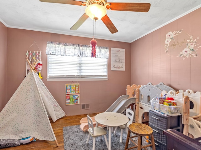 game room featuring ceiling fan, hardwood / wood-style floors, and crown molding