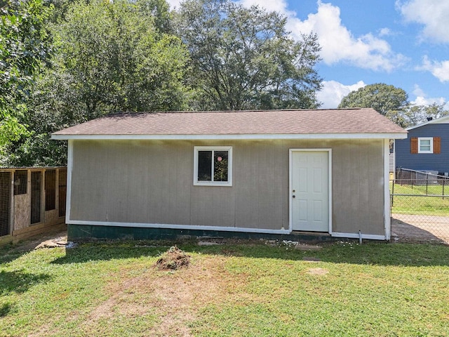 rear view of house featuring a yard