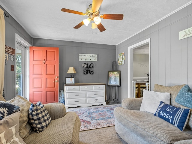 living room with a textured ceiling, carpet floors, and ceiling fan