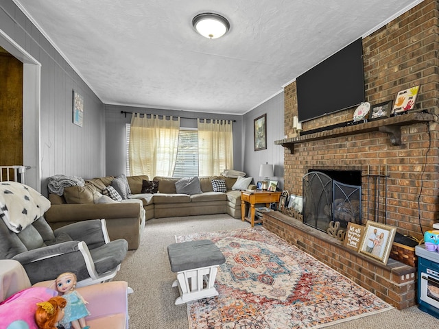 living room with brick wall, a textured ceiling, a brick fireplace, and carpet flooring